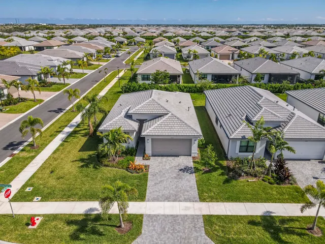 an aerial view of multiple houses with a yard
