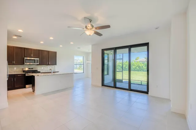 a view of large kitchen with a sink and a living room