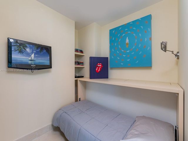 a bedroom with a bed and wall paintings