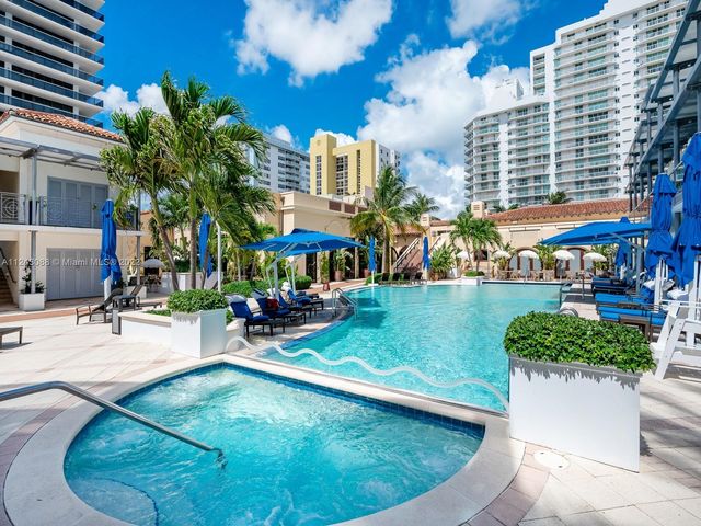 a view of a swimming pool with sitting area