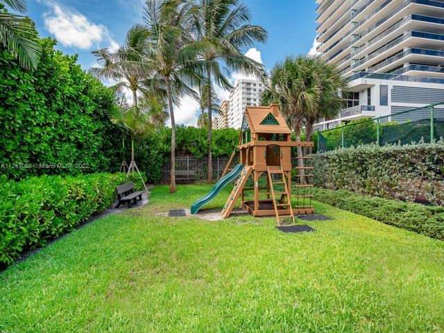 a front view of a house with a yard and green space