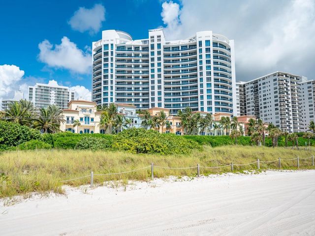 a front view of a building with garden and plants