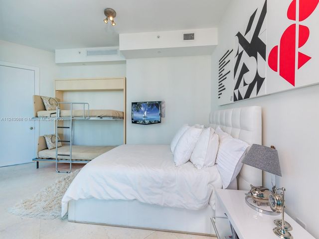 a bedroom with a bed and a chair