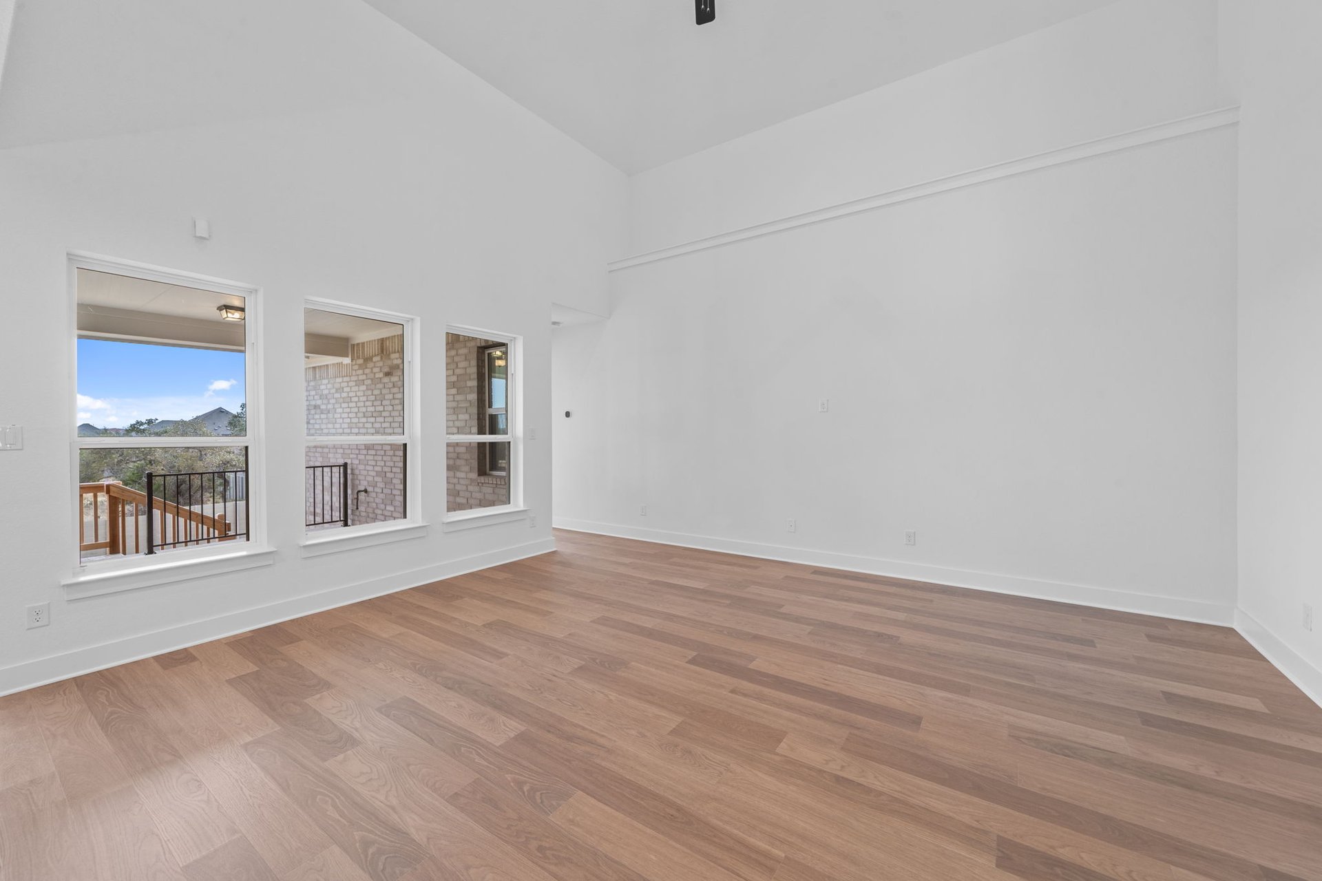 408 Texas Drive Georgetown, TX 78628 - Photo 15 of 39 an empty room with wooden floor and windows