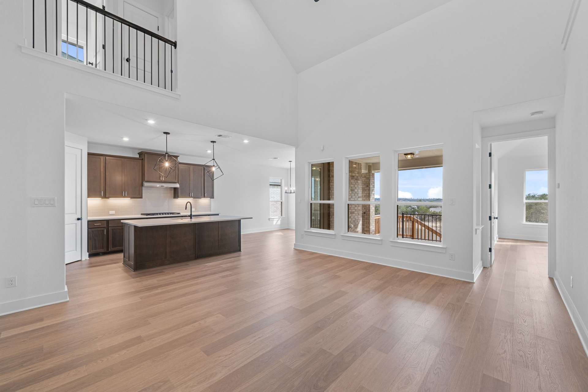 408 Texas Drive Georgetown, TX 78628 - Photo 17 of 39 a large white kitchen with large windows and wooden floor