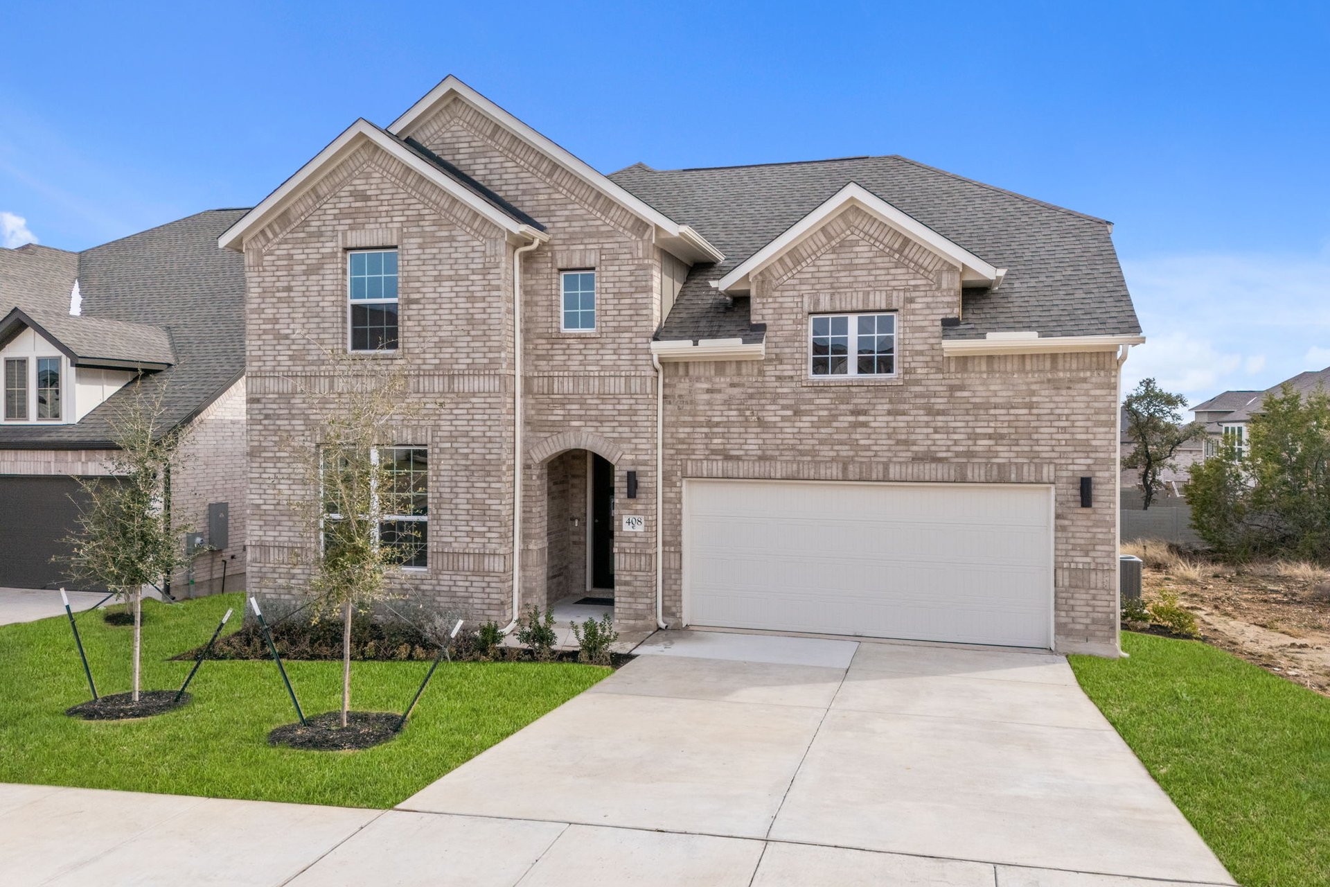 408 Texas Drive Georgetown, TX 78628 - Photo 2 of 39 a front view of a house with a yard and garage