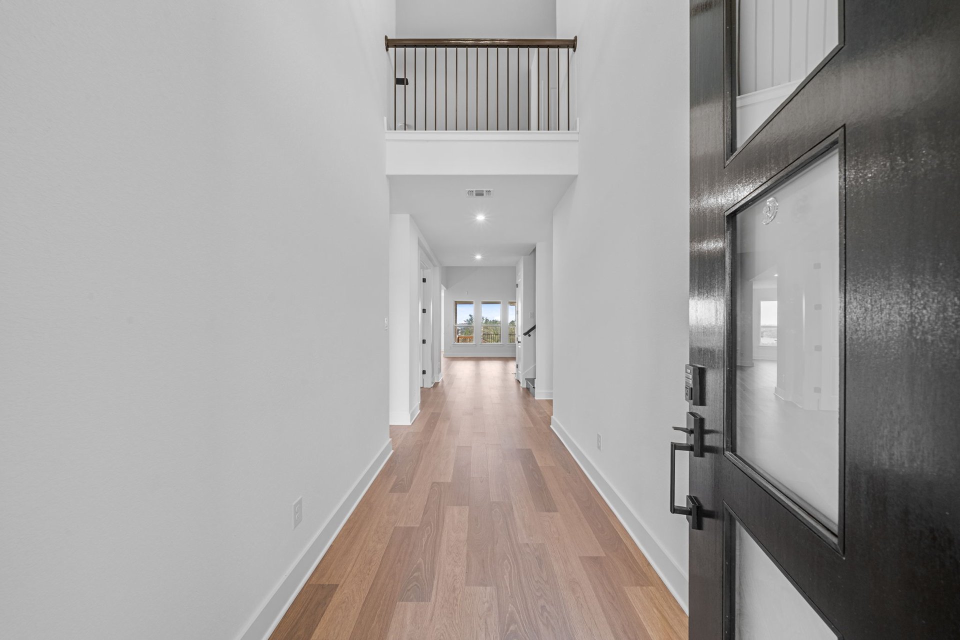 408 Texas Drive Georgetown, TX 78628 - Photo 8 of 39 a view of a hallway with wooden floor and staircase