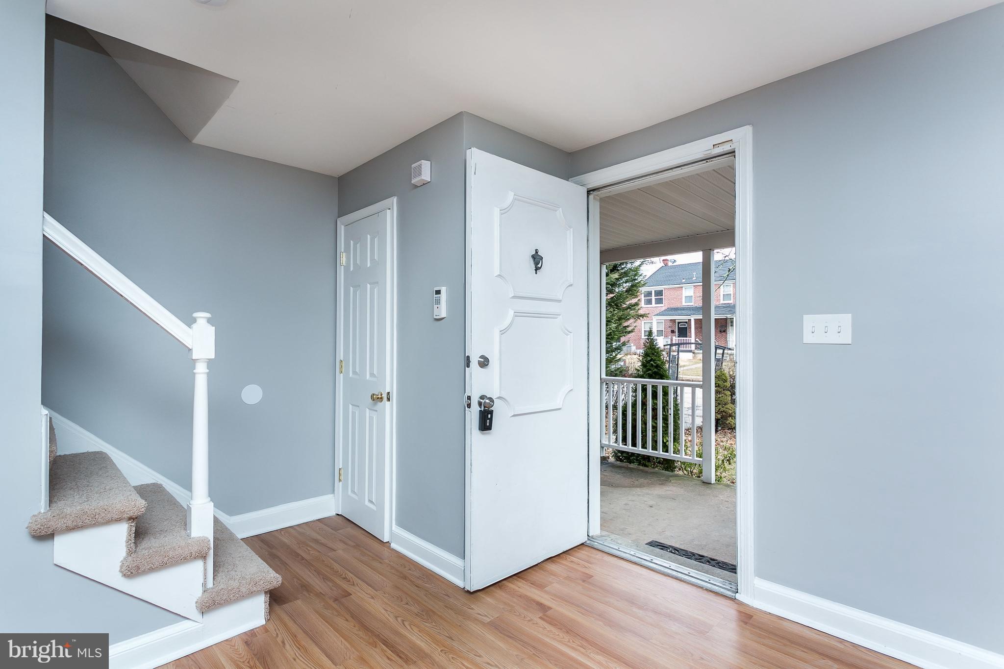 1033 Reverdy Road Baltimore, MD 21212 - Photo 2 of 29 a view of a hallway with wooden floor and a living room