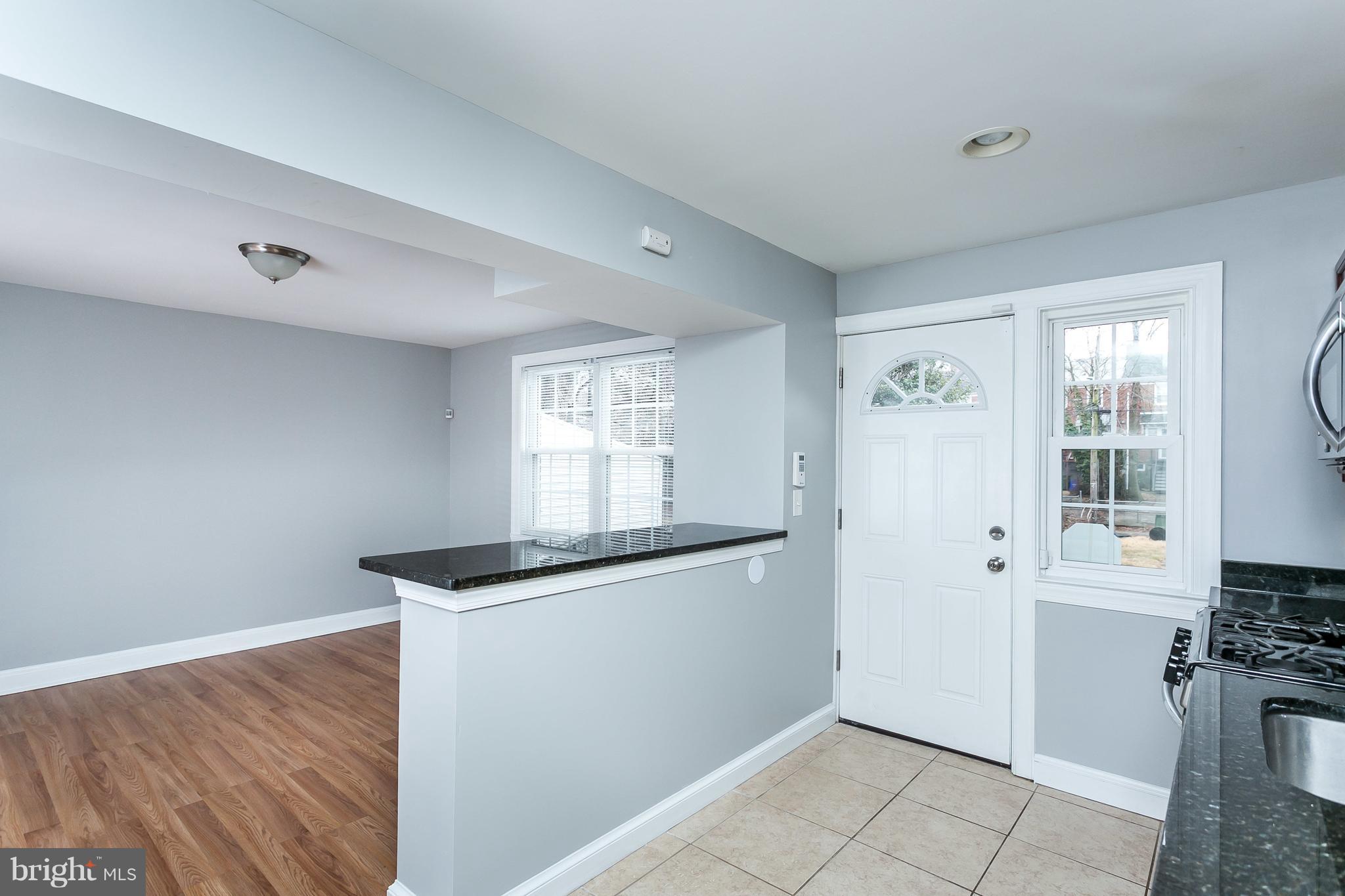 1033 Reverdy Road Baltimore, MD 21212 - Photo 13 of 29 a kitchen with granite countertop a sink cabinets and a window