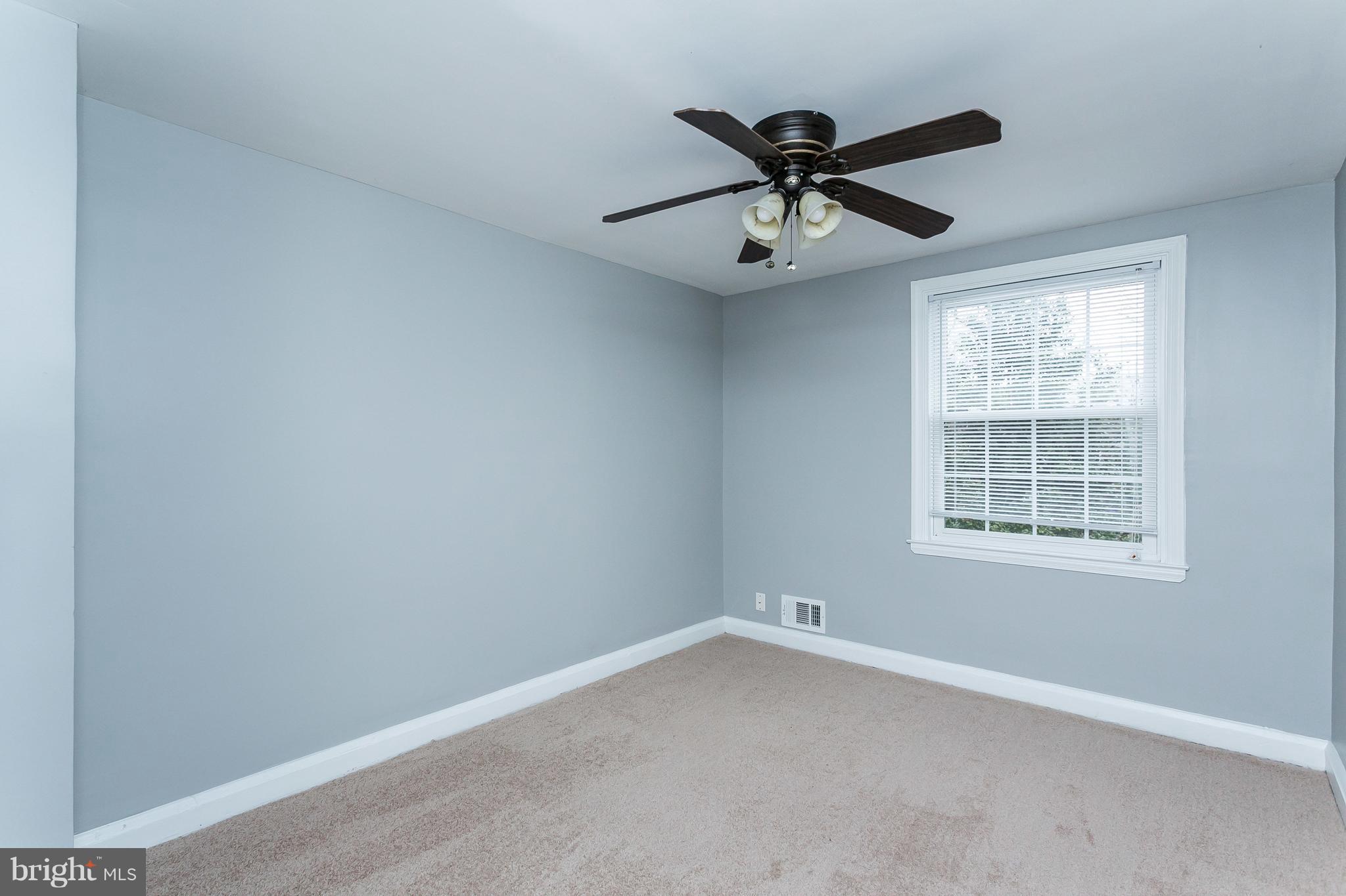 1033 Reverdy Road Baltimore, MD 21212 - Photo 19 of 29 an empty room with a window and a ceiling fan