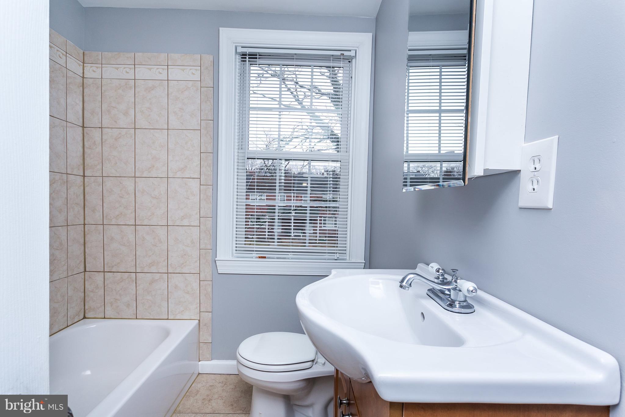 1033 Reverdy Road Baltimore, MD 21212 - Photo 22 of 29 a bathroom with a sink toilet and shower