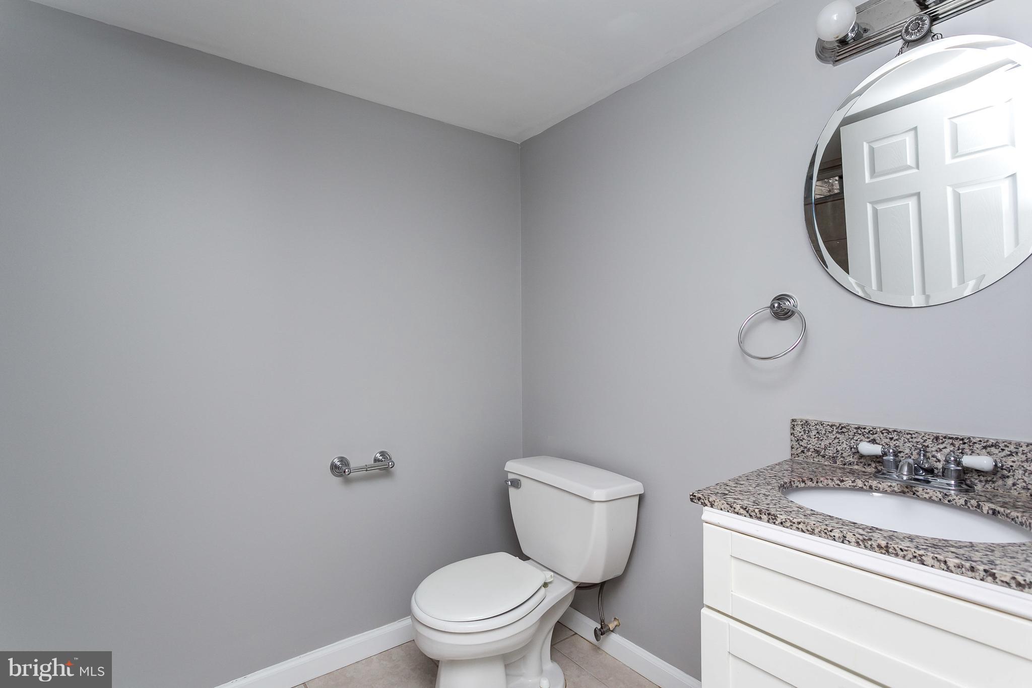 1033 Reverdy Road Baltimore, MD 21212 - Photo 26 of 29 a white toilet sitting next to a bathroom sink