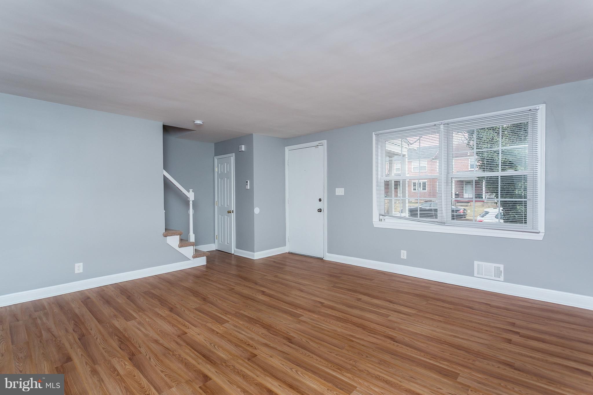 1033 Reverdy Road Baltimore, MD 21212 - Photo 4 of 29 a view of empty room with wooden floor and fan