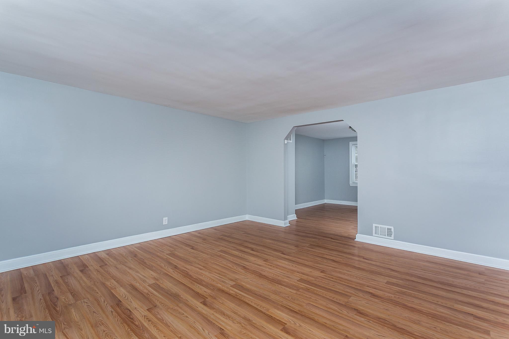 1033 Reverdy Road Baltimore, MD 21212 - Photo 5 of 29 a view of an empty room with wooden floor and closet