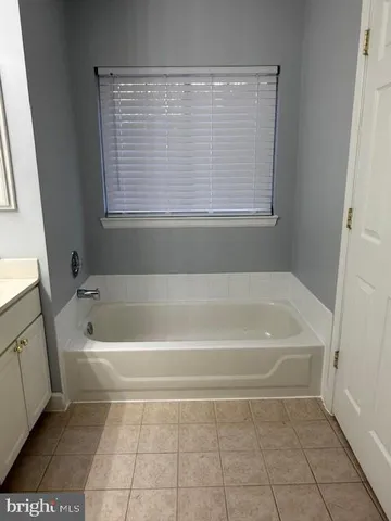a bath tub sitting in a bathroom next to a window