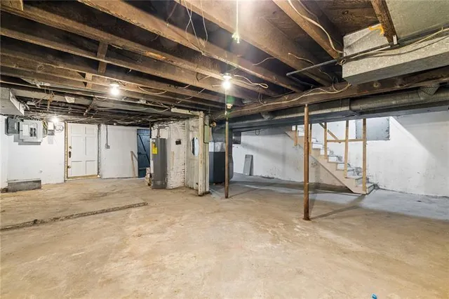 a view of a house with a big yard and a large tree