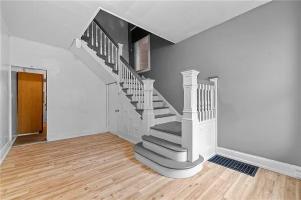 a view of entryway and hall with wooden floor