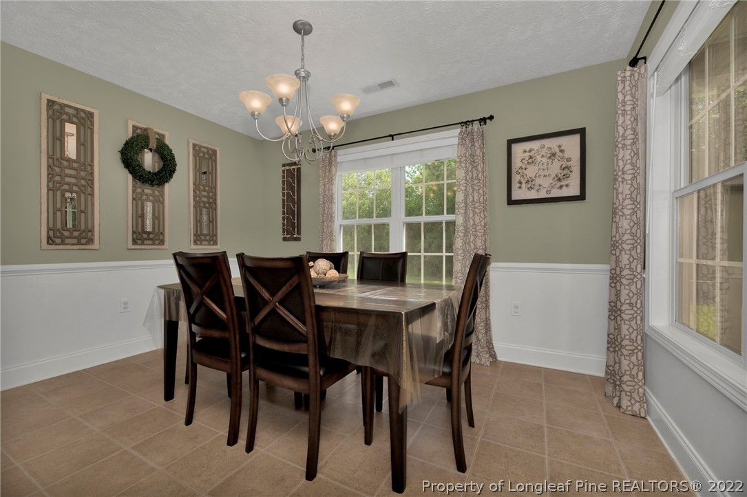 723 Cape Fear Road Raeford, NC 28376 - Photo 12 of 33 a view of a dining room with furniture and a chandelier