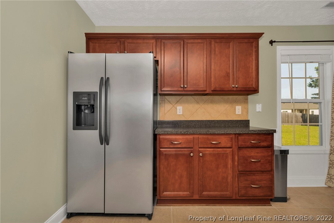 723 Cape Fear Road Raeford, NC 28376 - Photo 16 of 33 a kitchen with stainless steel appliances granite countertop a refrigerator and a stove