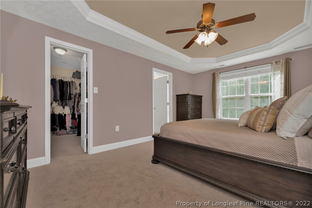 723 Cape Fear Road Raeford, NC 28376 - Photo 25 of 33 a bedroom with a large bed and a ceiling fan