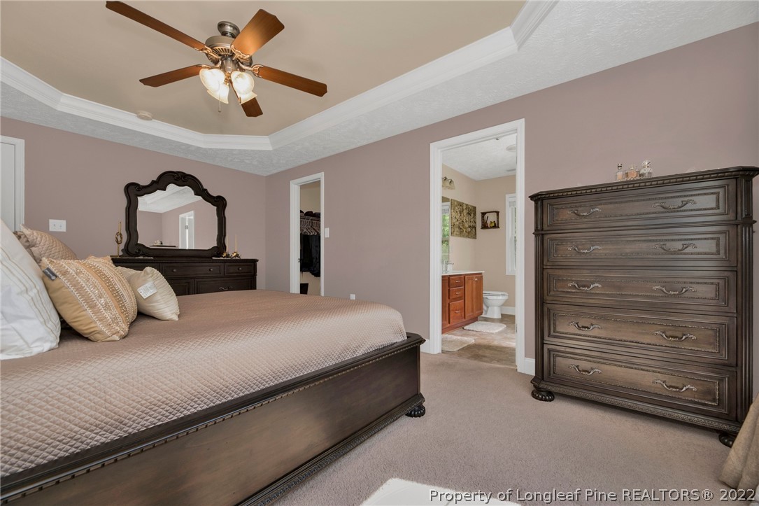 723 Cape Fear Road Raeford, NC 28376 - Photo 26 of 33 a bedroom with a bed and a chandelier