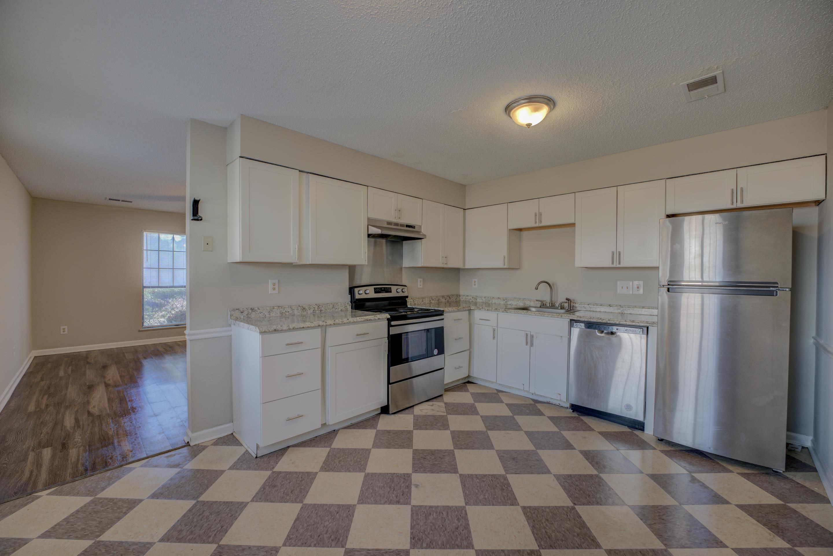 3501 Chowning Road Memphis, TN 38135 - Photo 11 of 25 Kitchen with sink, a textured ceiling, stainless steel appliances, light stone countertops, and white cabinets