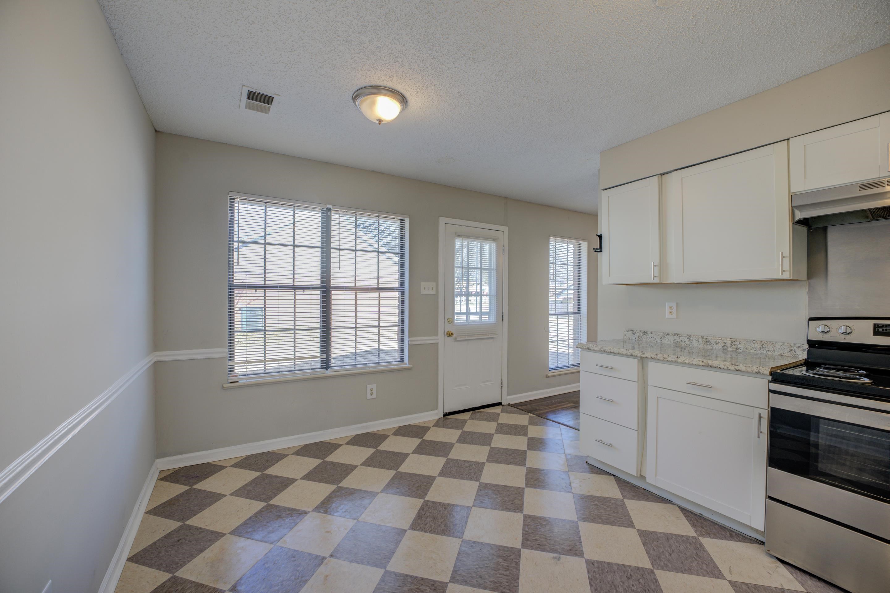 3501 Chowning Road Memphis, TN 38135 - Photo 12 of 25 Kitchen with electric stove, light stone counters, a textured ceiling, and white cabinets