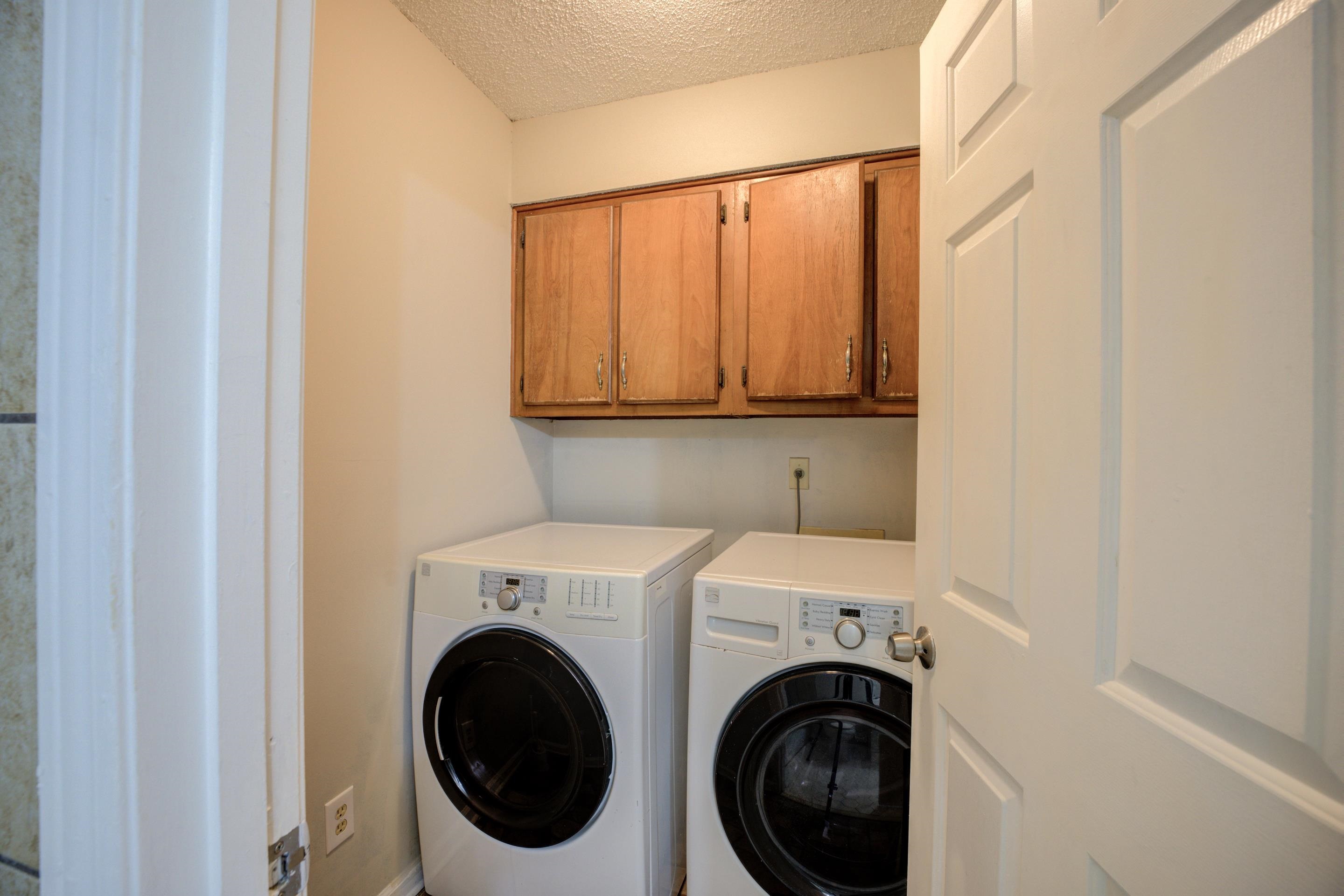3501 Chowning Road Memphis, TN 38135 - Photo 13 of 25 Laundry room with cabinets, washing machine and dryer, and a textured ceiling