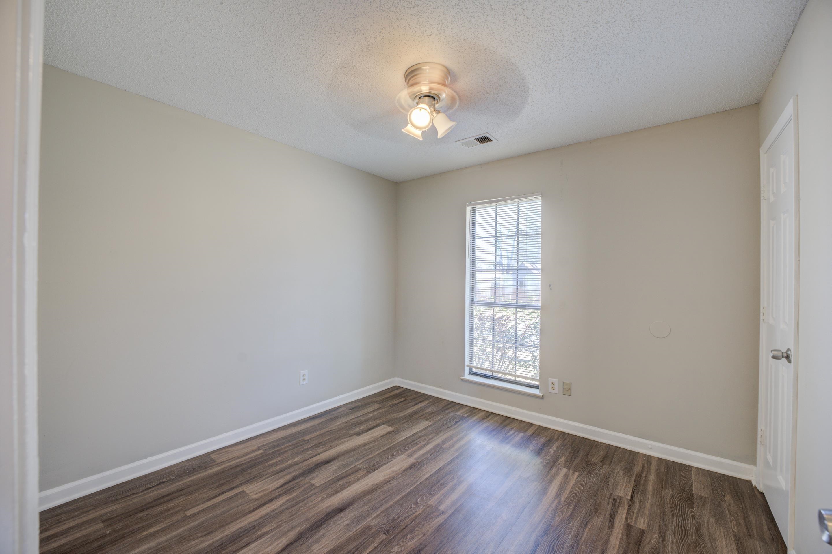 3501 Chowning Road Memphis, TN 38135 - Photo 14 of 25 Empty room with dark wood-type flooring, a textured ceiling, and ceiling fan