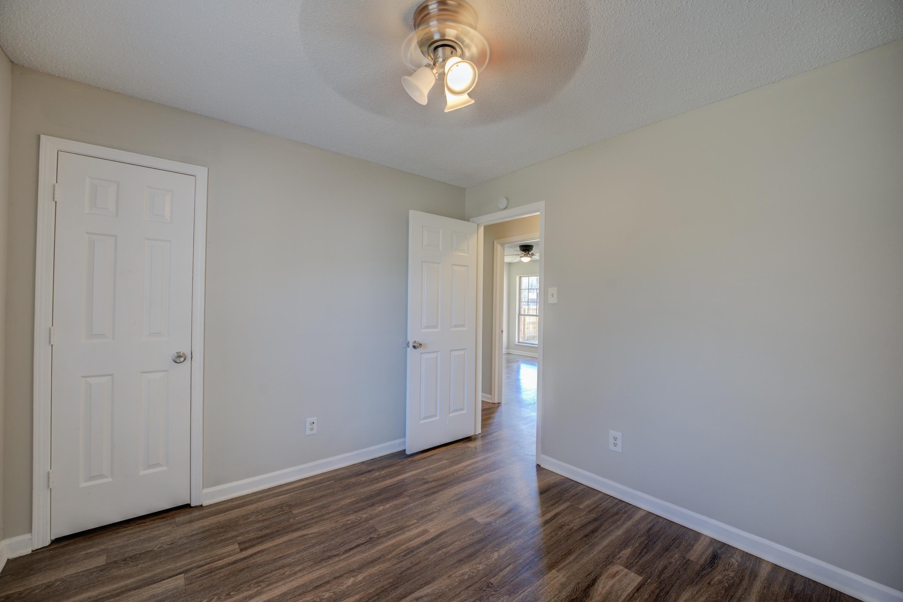 3501 Chowning Road Memphis, TN 38135 - Photo 15 of 25 Empty room with ceiling fan, dark hardwood / wood-style flooring, and a textured ceiling