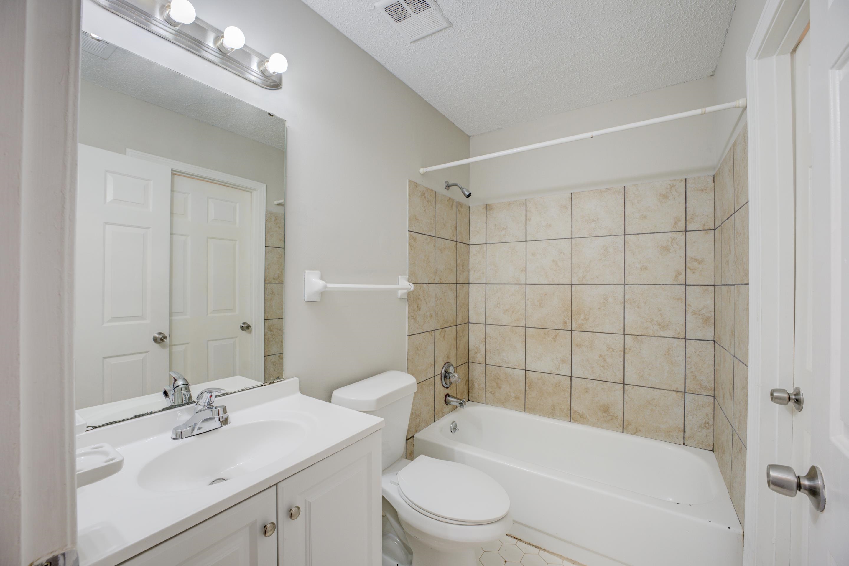 3501 Chowning Road Memphis, TN 38135 - Photo 6 of 25 Full bathroom with vanity, tiled shower / bath, a textured ceiling, and toilet