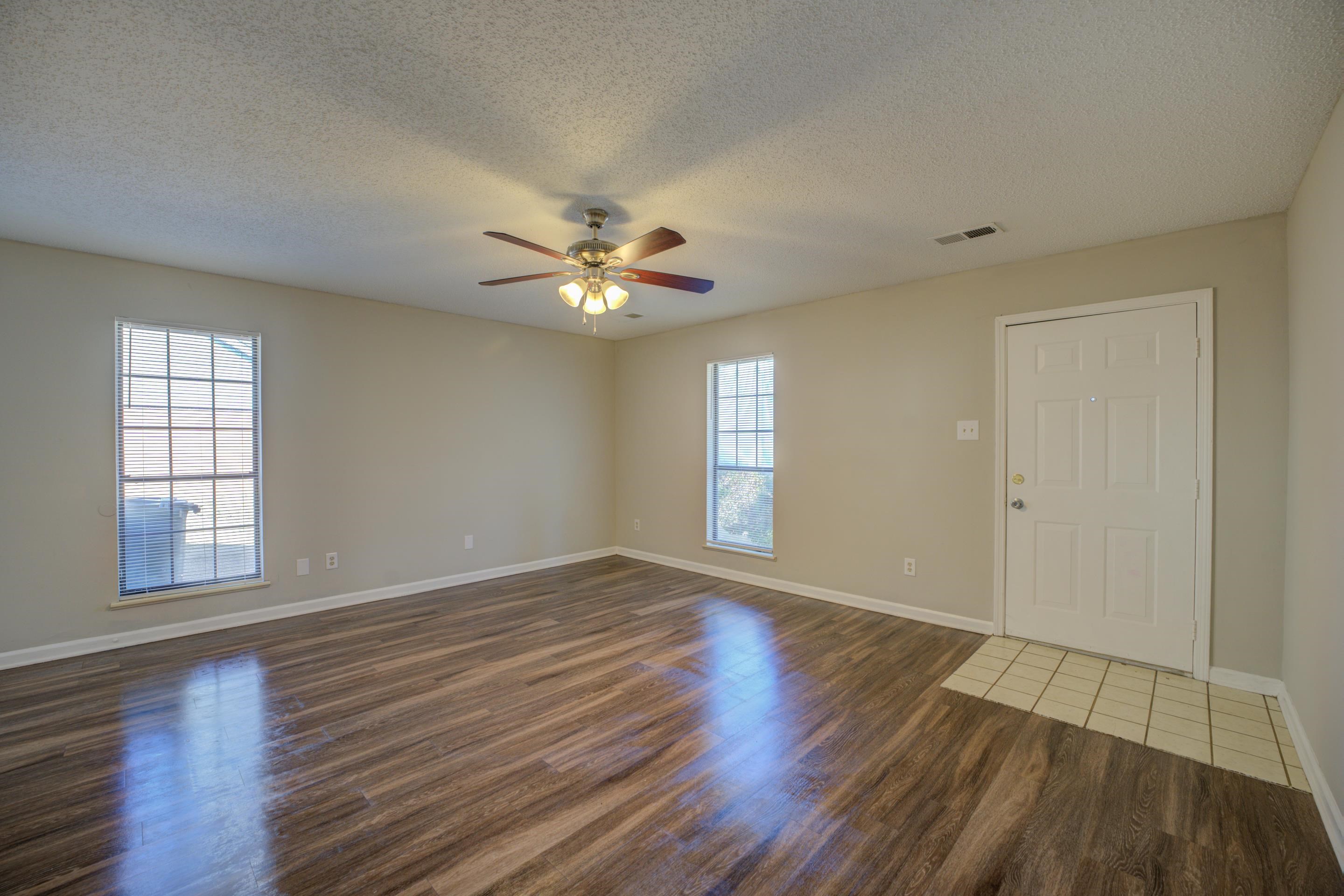 3501 Chowning Road Memphis, TN 38135 - Photo 9 of 25 Empty room with ceiling fan, dark hardwood / wood-style floors, and a textured ceiling