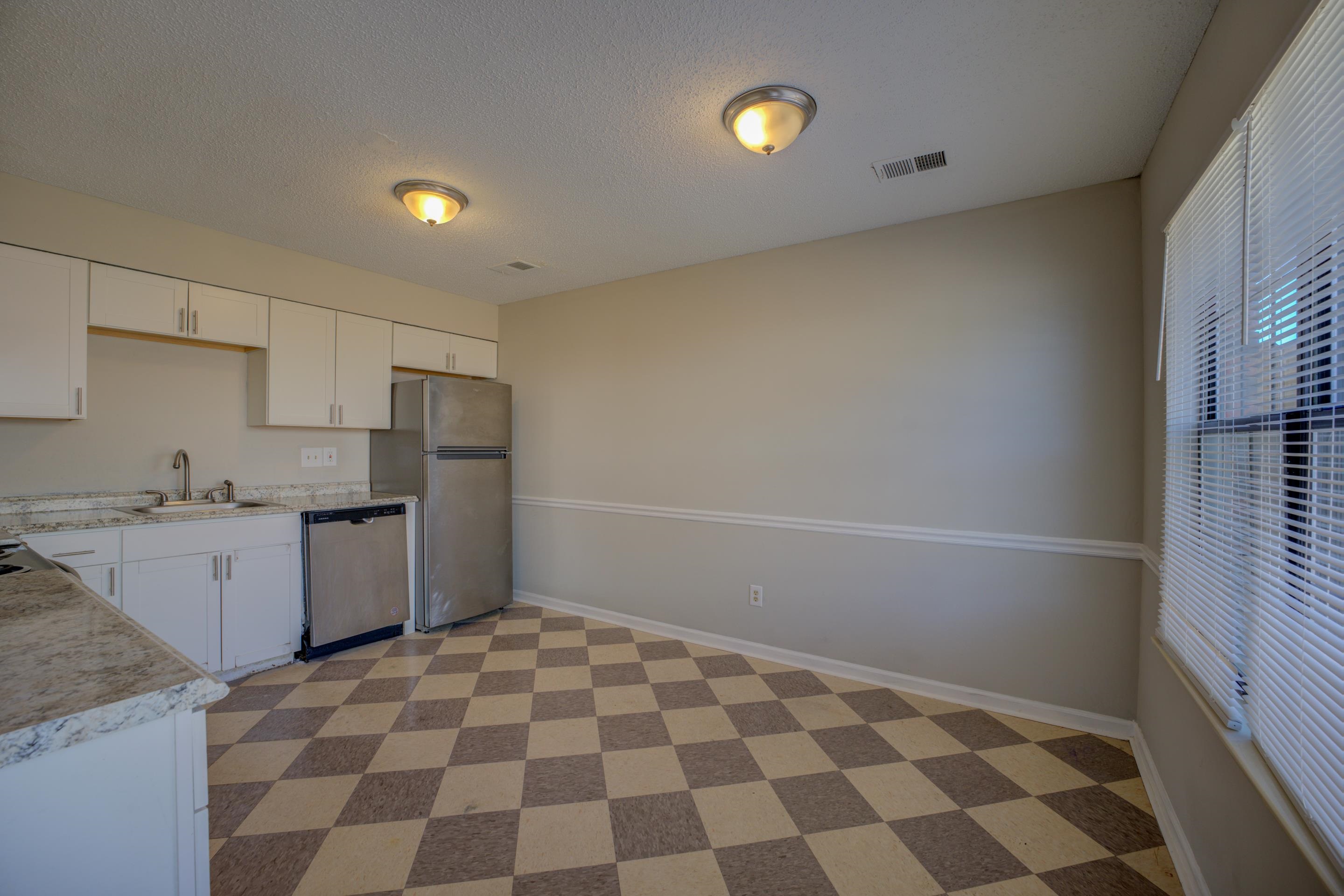 3501 Chowning Road Memphis, TN 38135 - Photo 10 of 25 Kitchen featuring white cabinetry, sink, a textured ceiling, and appliances with stainless steel finishes