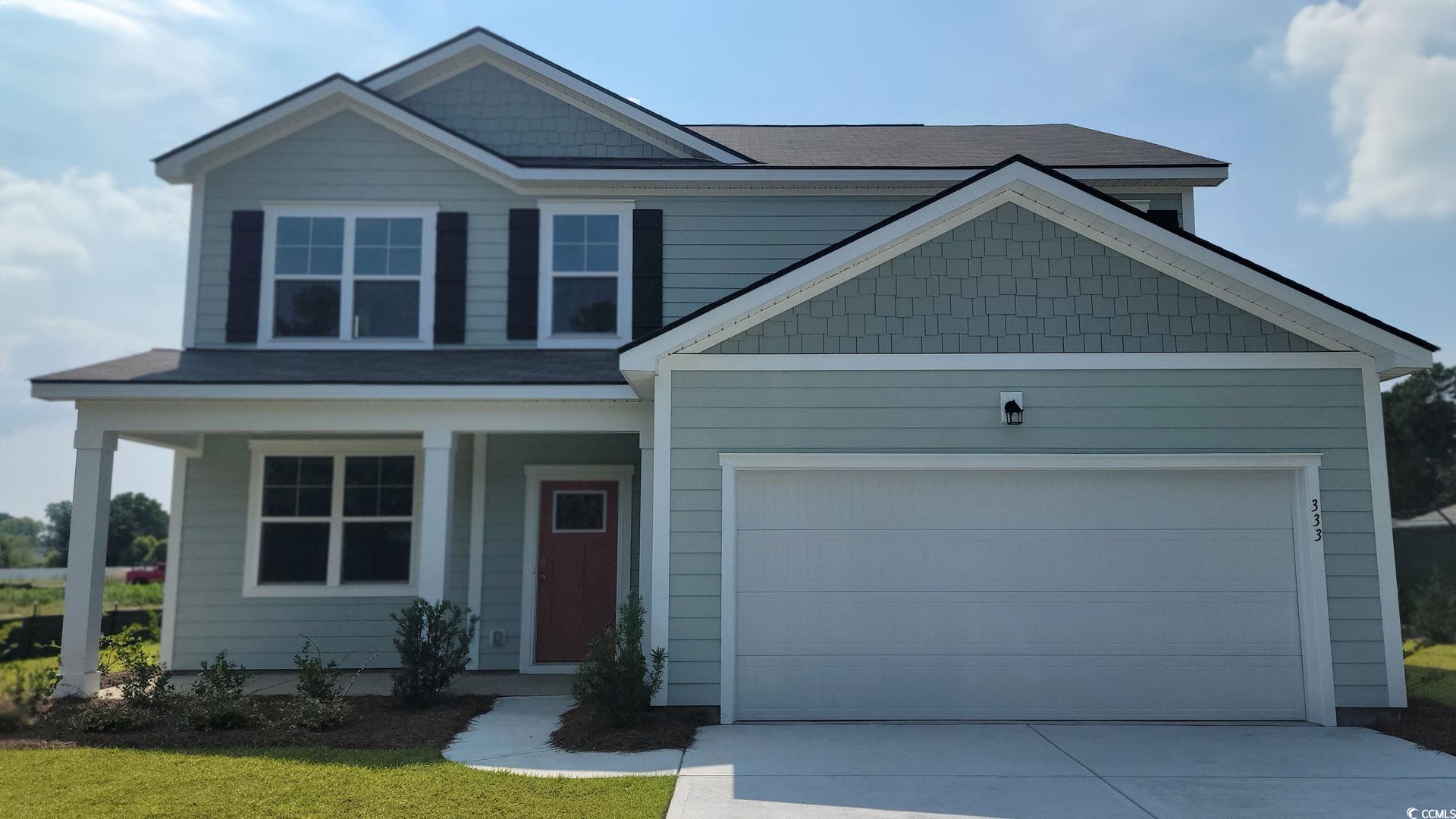 Craftsman inspired home featuring a porch, a garage, and concrete driveway