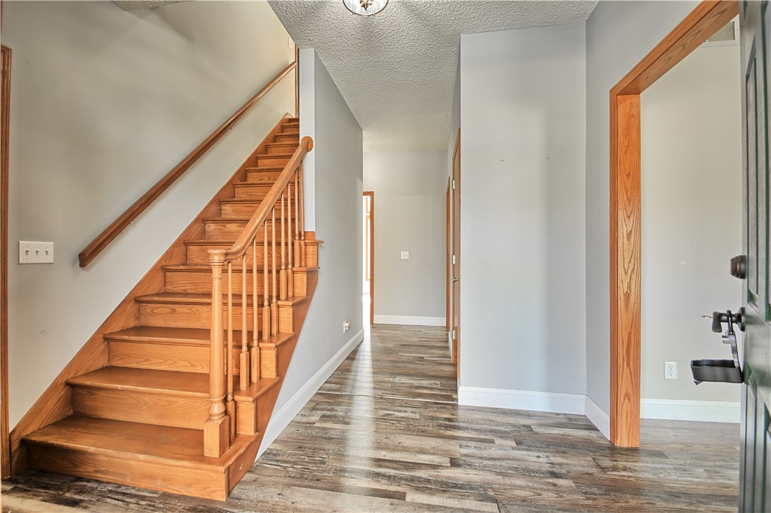 8711 Nicole Lane Springboro, OH 45066 - Photo 6 of 87 This inviting entrance foyer showcases rich hardwood stairs and durable vinyl flooring.
