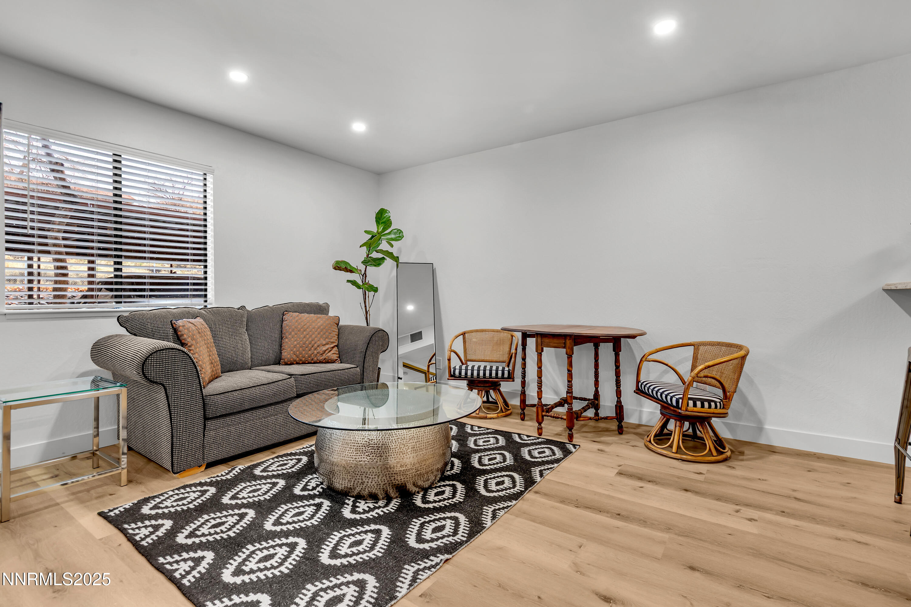 a living room with furniture a rug and a window