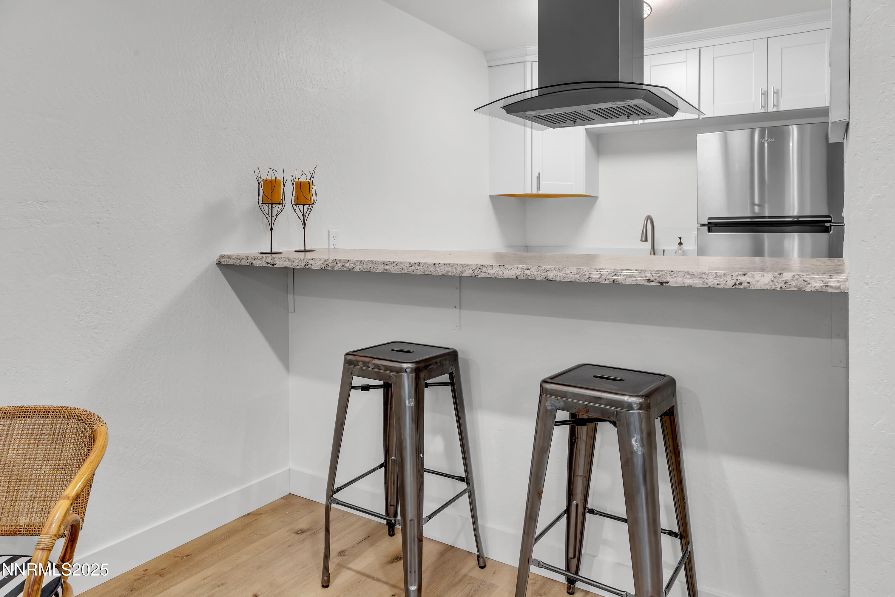 1000 Beck Drive, Unit 163 Reno, NV 89509 - Photo 3 of 14 a kitchen with stainless steel appliances granite countertop a table chairs in it and wooden floors
