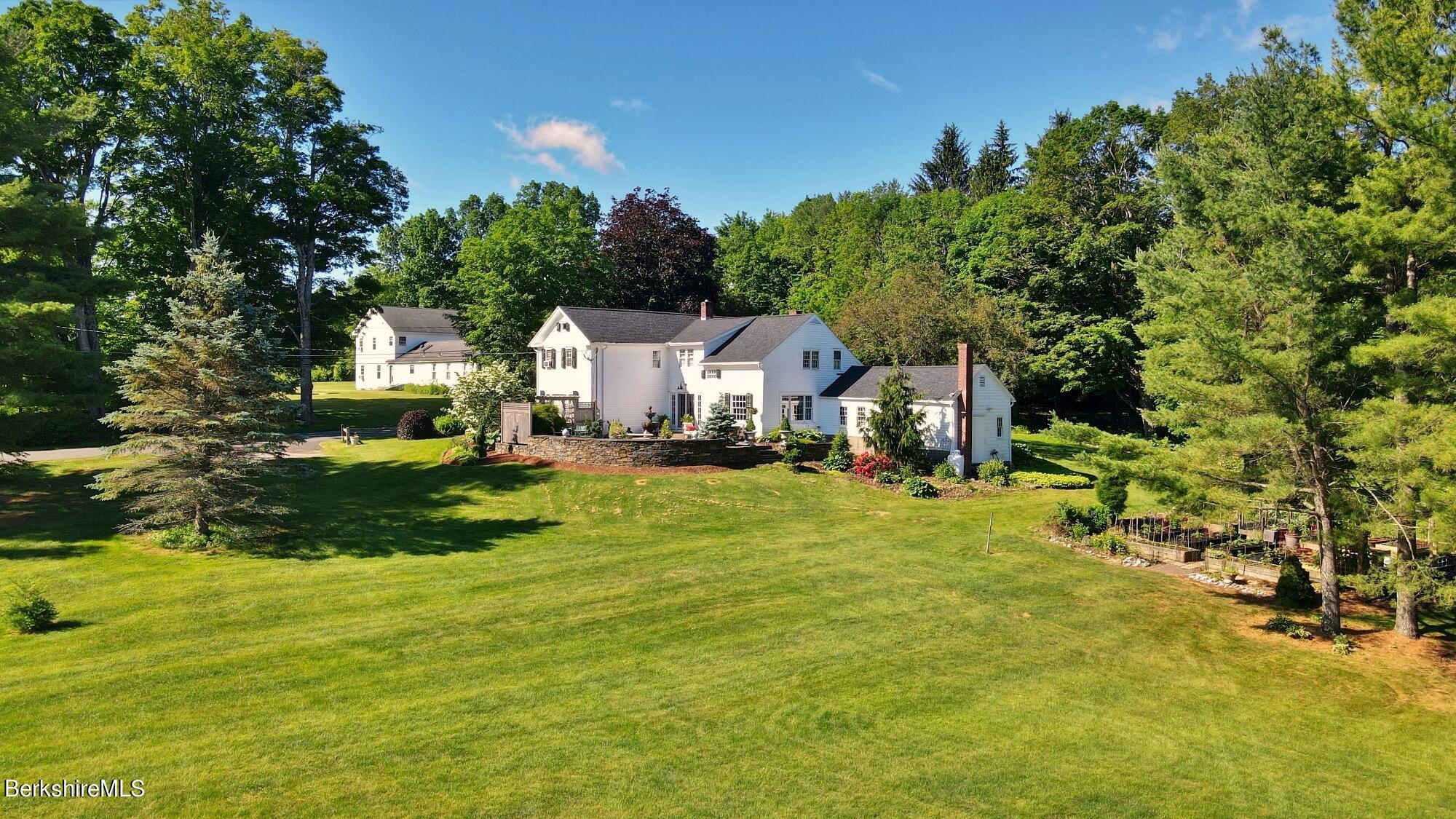 500 Devon Road Lee, MA 01238 - Photo 2 of 59 a front view of a house with a yard