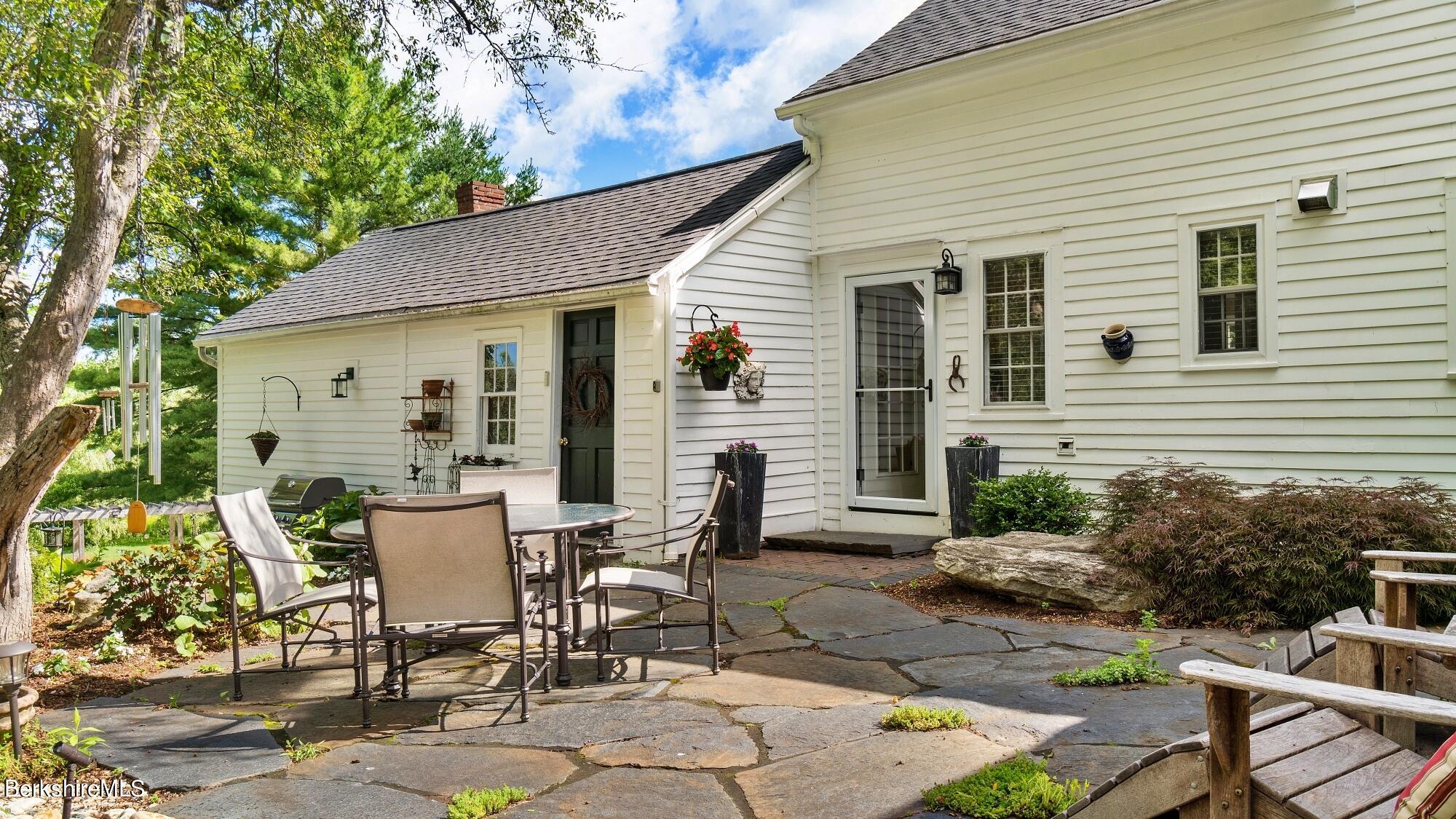 500 Devon Road Lee, MA 01238 - Photo 22 of 59 a view of a patio with table and chairs and potted plants