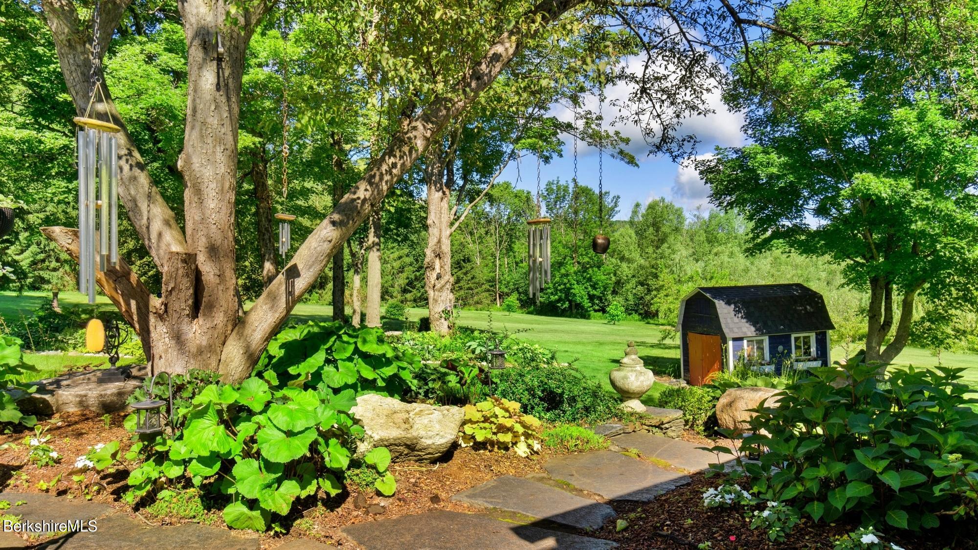 500 Devon Road Lee, MA 01238 - Photo 25 of 59 a view of a garden with a bench