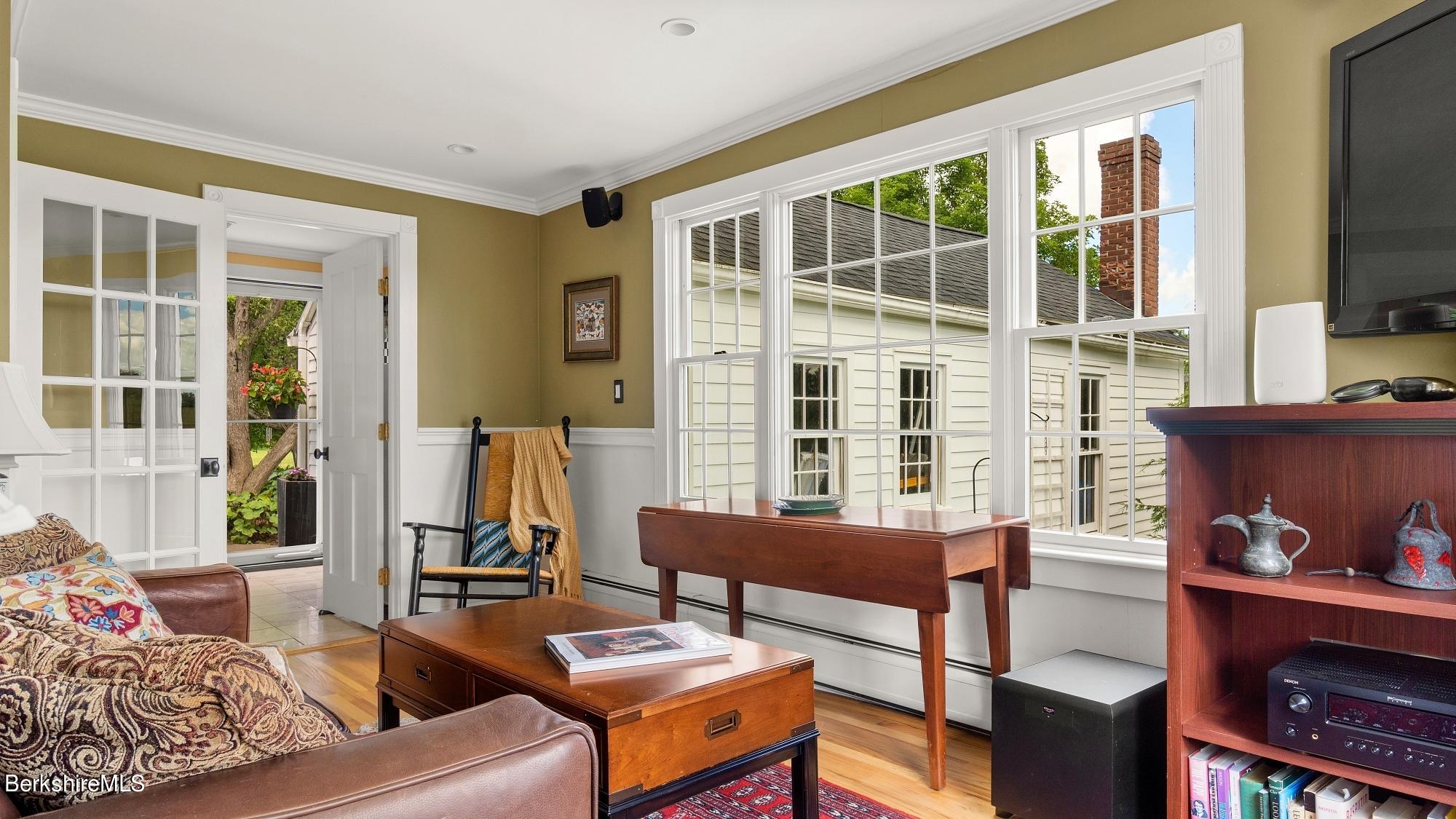 500 Devon Road Lee, MA 01238 - Photo 44 of 59 a living room with furniture a flat screen tv and large windows