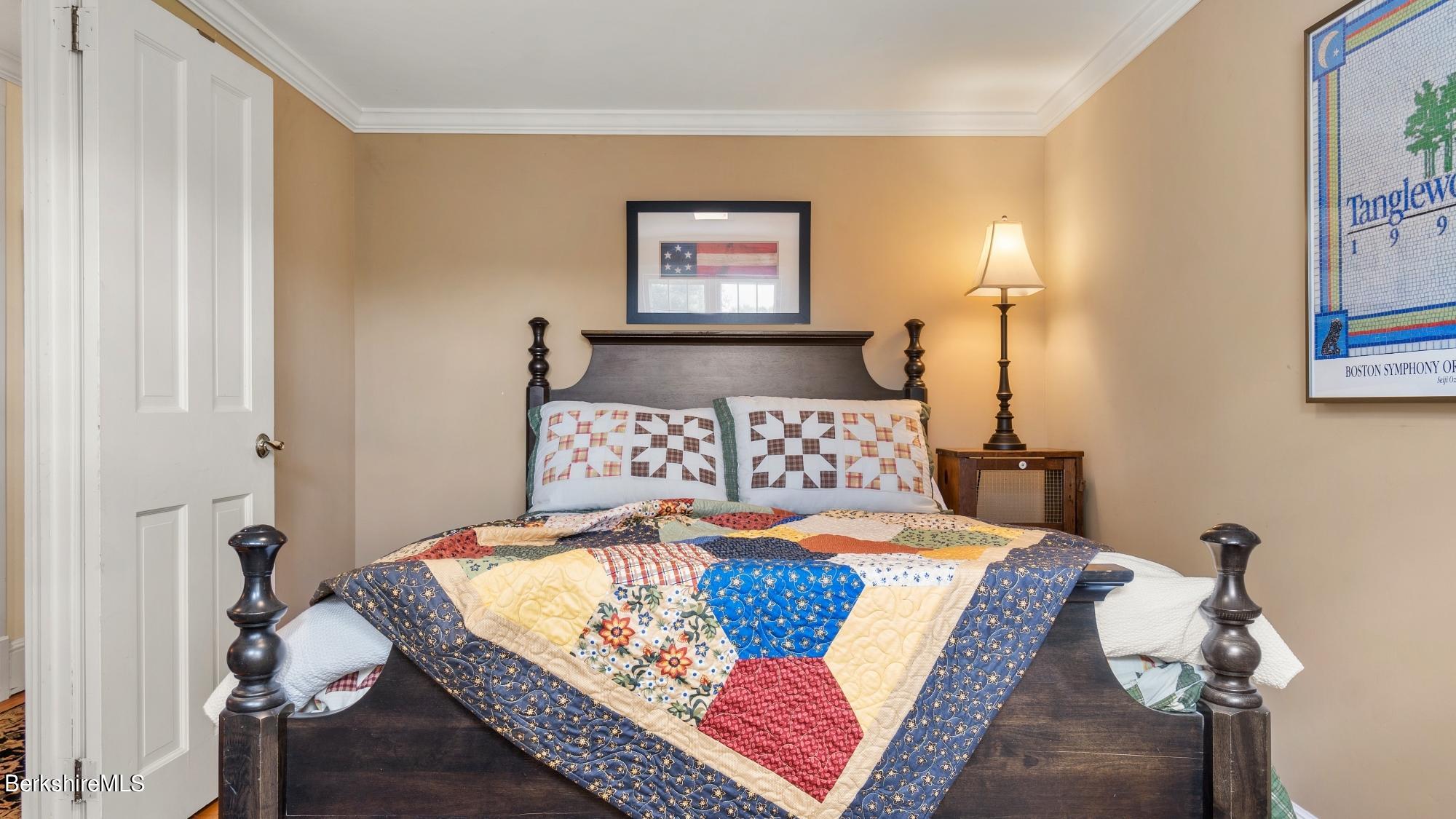 500 Devon Road Lee, MA 01238 - Photo 58 of 59 a bedroom with a bed and a painting on the wall