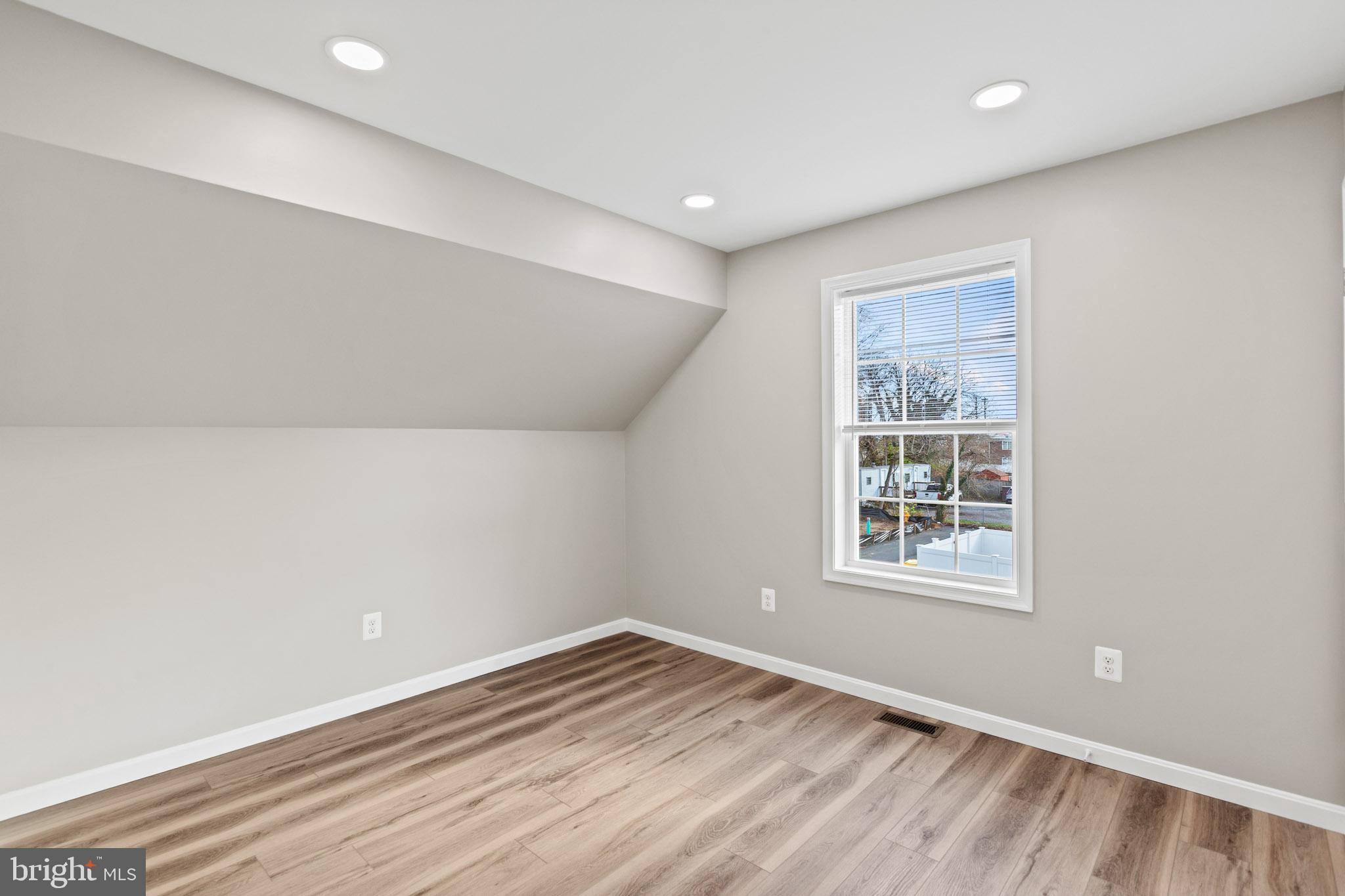 41599 Church Street Leonardtown, MD 20650 - Photo 13 of 22 an empty room with wooden floor and windows