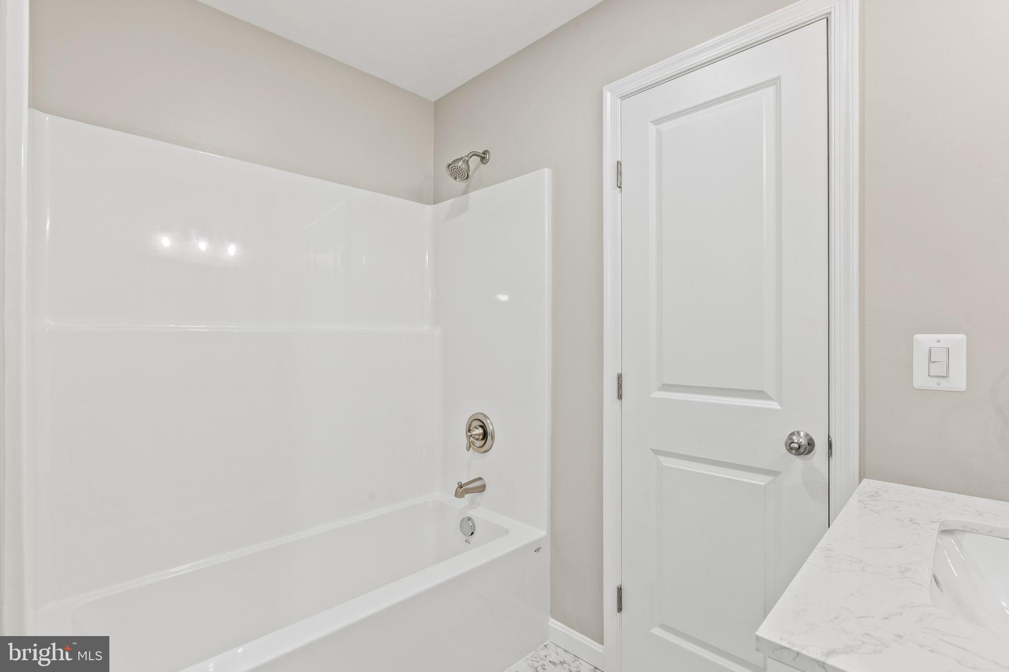 41599 Church Street Leonardtown, MD 20650 - Photo 18 of 22 a bathroom with a bathtub and a shower