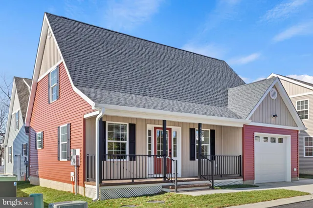 a view of a house with wooden deck and a yard