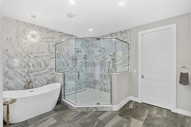 a bathroom with a bathtub and a shower