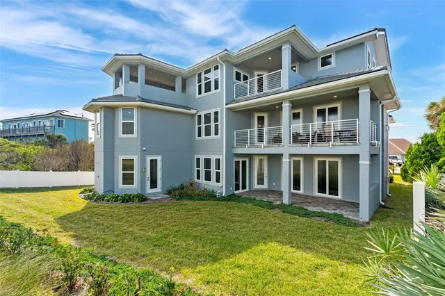 a living room with furniture a fireplace and a potted plant
