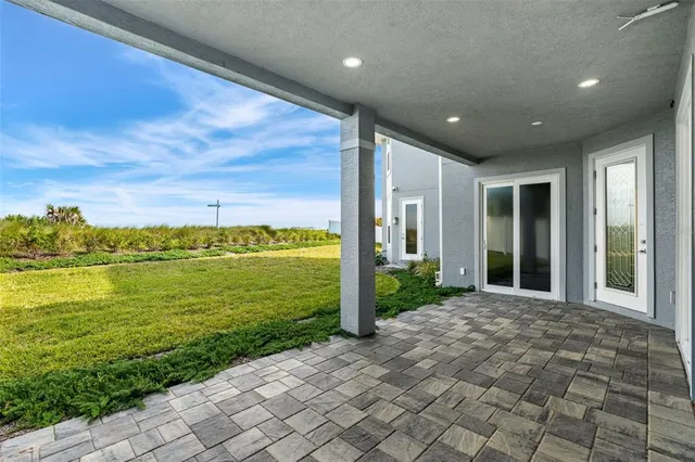 an aerial view of residential houses with outdoor space and river