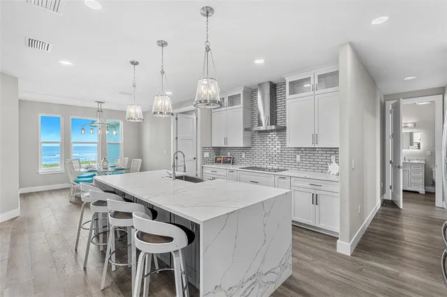 a kitchen with a table chairs sink and cabinets