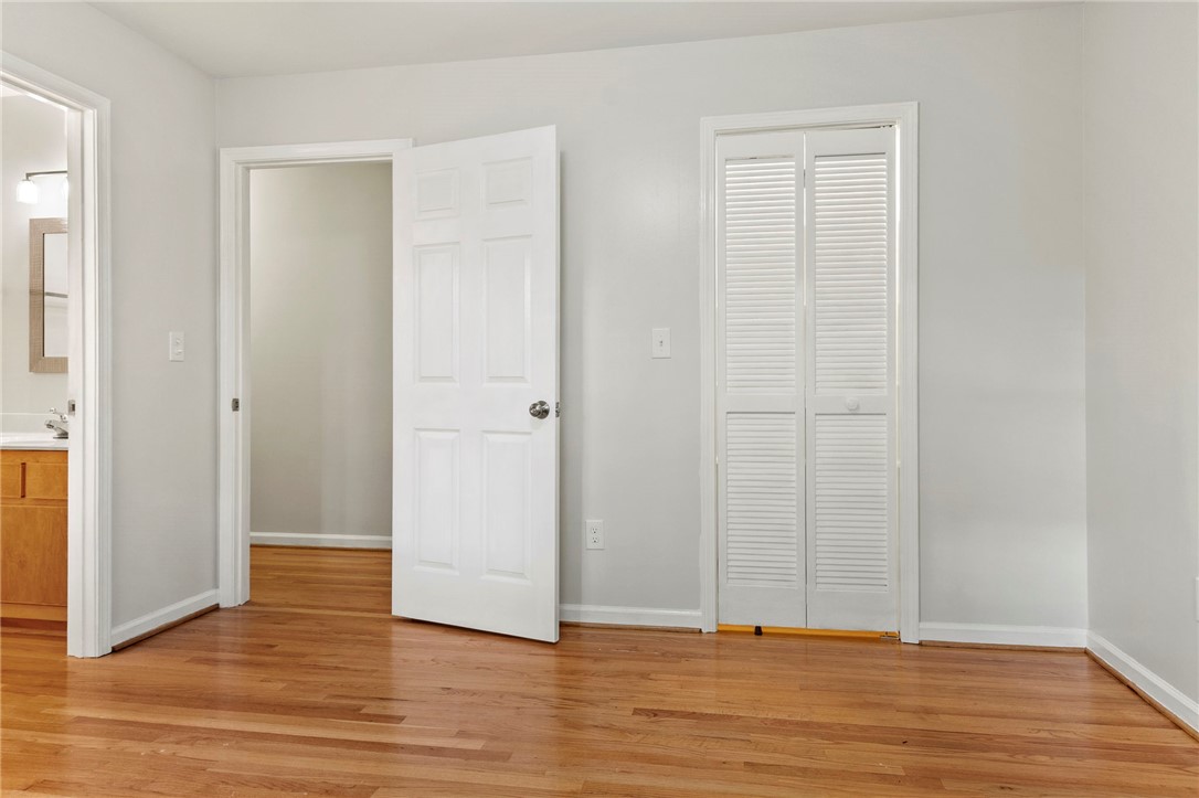 225 Arrowhead Trail Easley, SC 29642 - Photo 16 of 33 This bright room features warm hardwood flooring, connecting seamlessly to an adjoining bath and beyond.